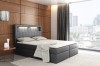 Schwarzes Boxspringbett mit LED-Beleuchtung im Kopfteil vor Panoramafenster