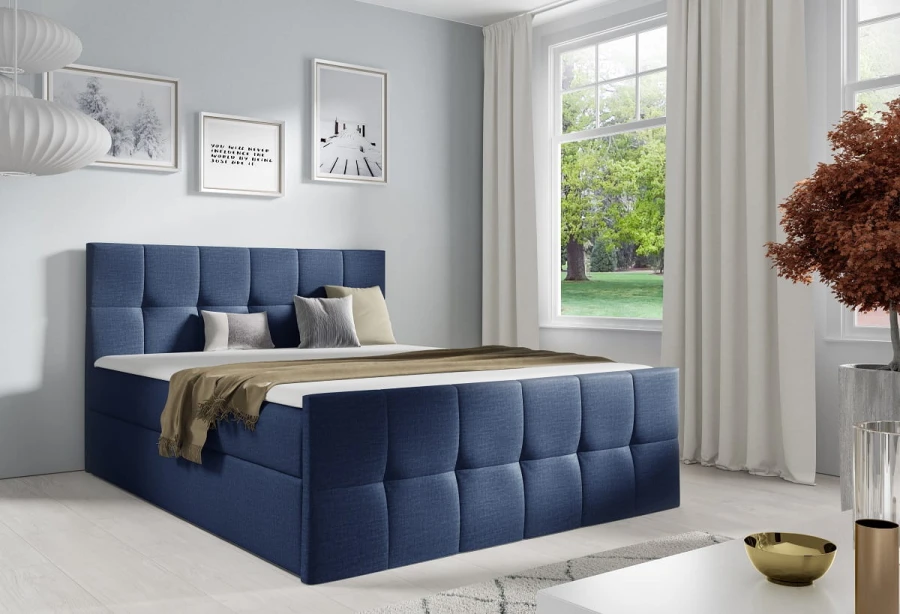 Dunkelblaues Boxspringbett mit hochwertigem Stoffbezug und Steppmuster
