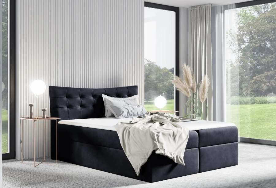Dunkelblaues Boxspringbett aus Samt mit hohem Kopfteil in einem modernen, lichtdurchfluteten Zimmer.