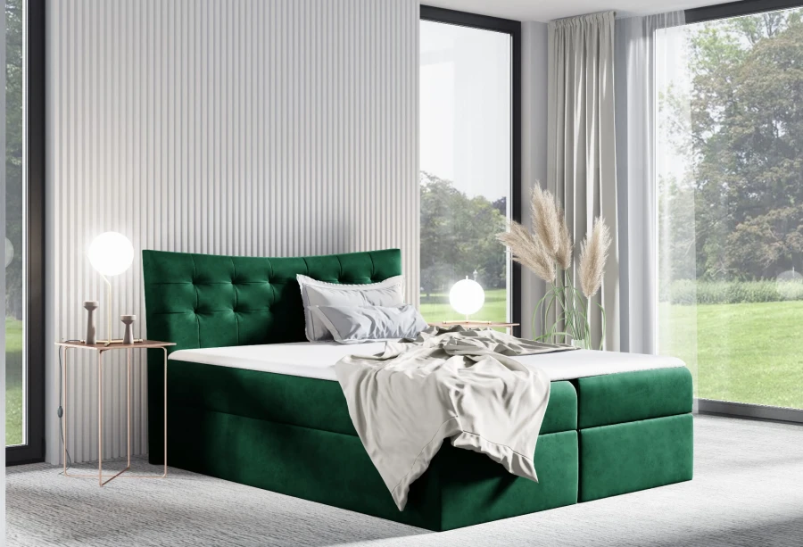 Luxuriöses Boxspringbett in Smaragdgrün mit Samtbezug und dekorativer Knopfheftung am Kopfteil.