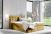 Stilvolles senfgelbes Boxspringbett in einem hellen, modernen Schlafzimmer-Ambiente.