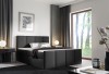 Anthrazitfarbenes Boxspringbett für ein exklusives Schlafzimmer.