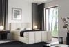 Modernes Boxspringbett in Beige mit gepolstertem Kopfteil und gemütlichem Design.