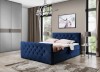 Dunkelblaues Boxspringbett mit dekorativer Steppung und Kristalldetails im Schlafzimmer.