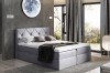 Graues Boxspringbett mit Rautenheftung im Schlafzimmer.
