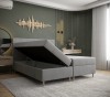 Graues Boxspringbett mit praktischem Bettkasten für zusätzlichen Stauraum im Schlafzimmer.