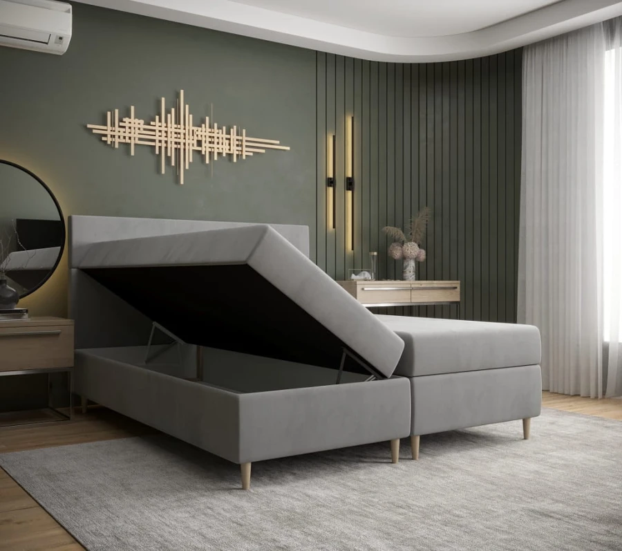 Graues Boxspringbett mit praktischem Bettkasten für zusätzlichen Stauraum im Schlafzimmer.