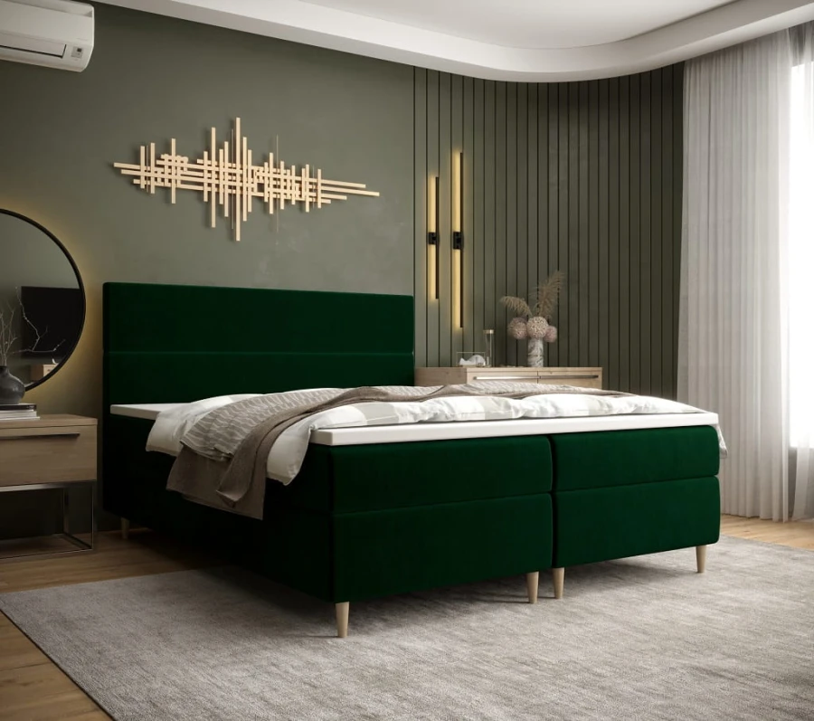 Elegantes Boxspringbett in Smaragdgrün mit hochwertigem Samtbezug im modernen Design.
