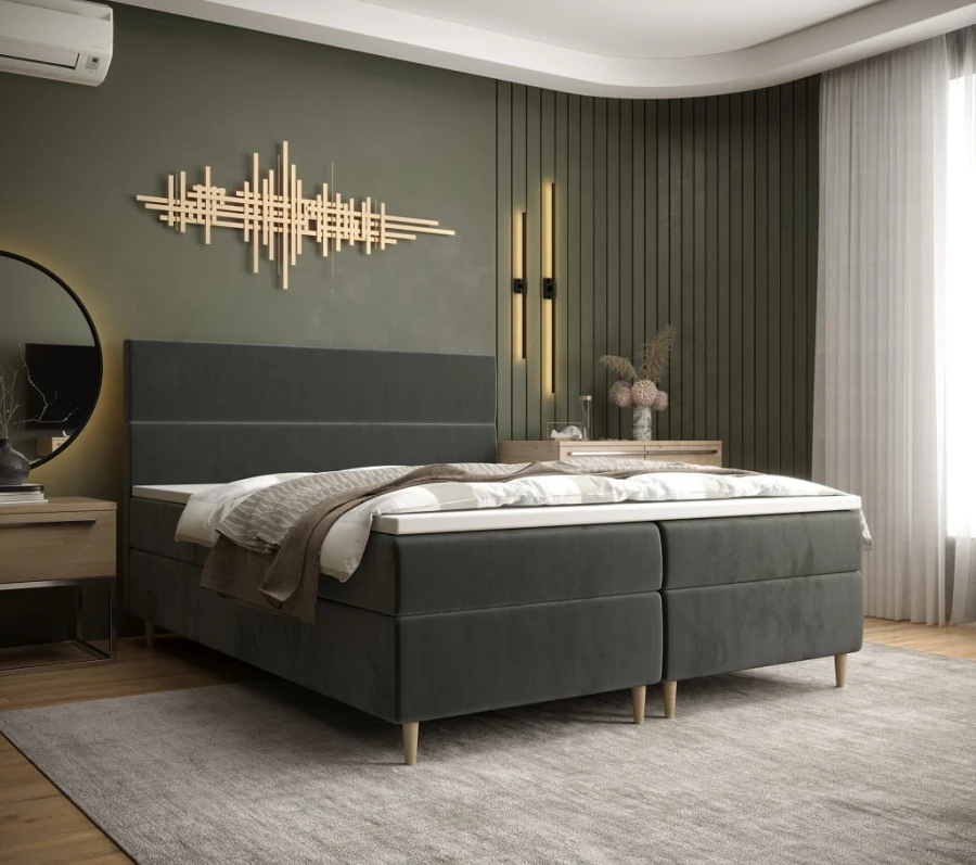 Graues Boxspringbett in modernem Schlafzimmer mit stilvoller Wandkunst