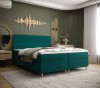 Türkises Boxspringbett in modernem Schlafzimmer mit grünem Hintergrund