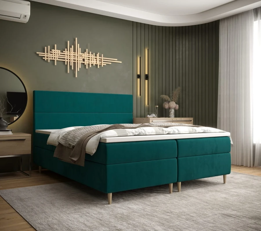 Türkises Boxspringbett in modernem Schlafzimmer mit grünem Hintergrund
