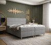 Modernes Boxspringbett in Grau mit gepolstertem Kopfteil im Schlafzimmer.