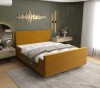 Modernes Polsterbett in Gelb als farblicher Akzent im Schlafzimmer.