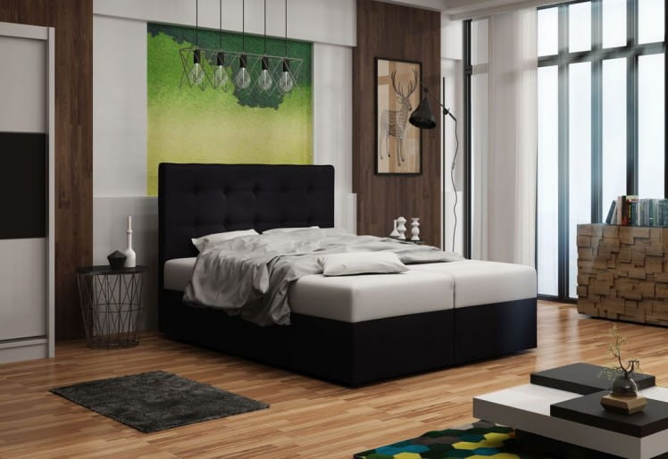 Schwarzes Boxspringbett mit hohem Kopfteil in einem hellen, modernen Schlafzimmer.
