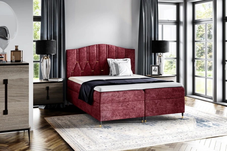 Luxuriöses Boxspringbett in Rot mit gestepptem Kopfteil im modernen Schlafzimmer.