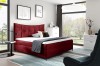 Elegantes Boxspringbett in Dunkelrot im modernen Schlafzimmer mit hellem Teppich und Dekoration.