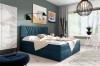 Dunkelblaues Boxspringbett mit modernem Kopfteil in stilvollem Schlafzimmer-Interieur.