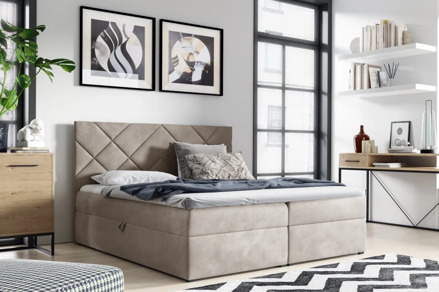 Modernes Boxspringbett in Beige mit gestepptem Kopfteil in einem hellen Schlafzimmer.