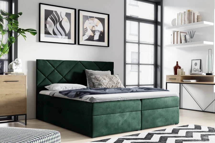 Modernes Boxspringbett in Dunkelgrün mit gestepptem Kopfteil in einem hellen Schlafzimmer.