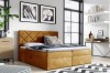 Senfgelbes Boxspringbett mit samtigem Bezug und gestepptem Kopfteil im modernen Wohndesign.
