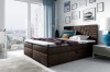 Dunkelbraunes Boxspringbett in elegantem Schlafzimmer mit blauen Akzenten
