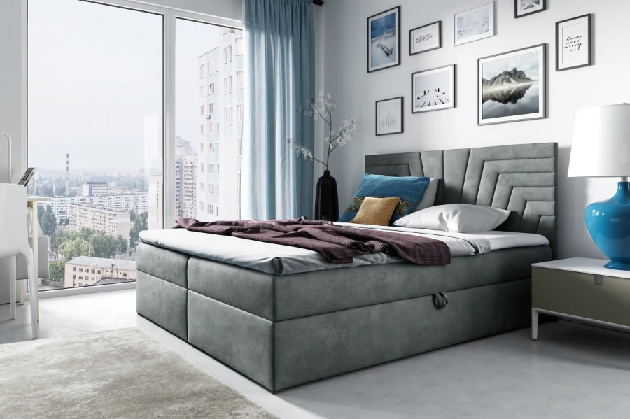 Stilvolles graues Boxspringbett mit geometrischem Kopfteil-Design.