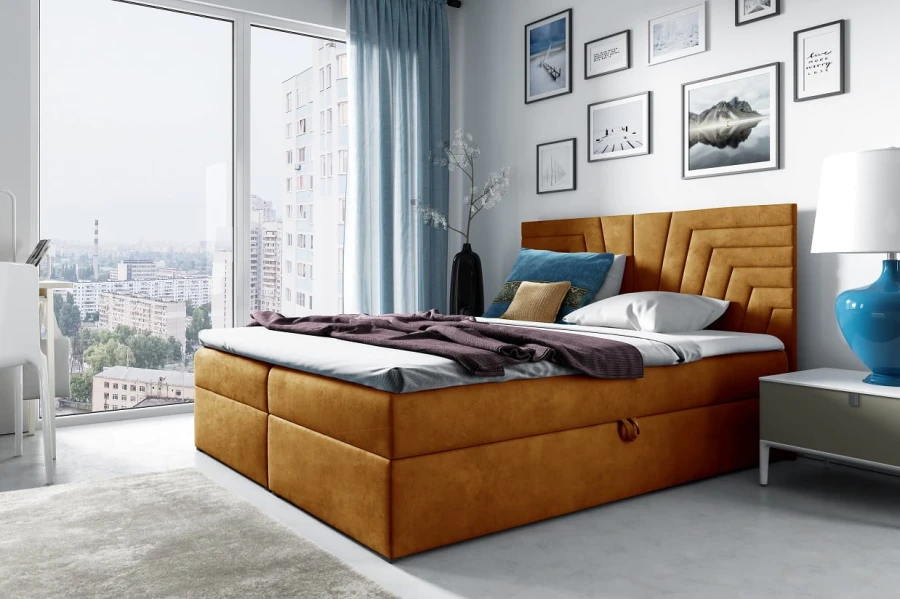 Boxspringbett in Senfgelb mit samtigem Polsterbezug und Bettkasten.