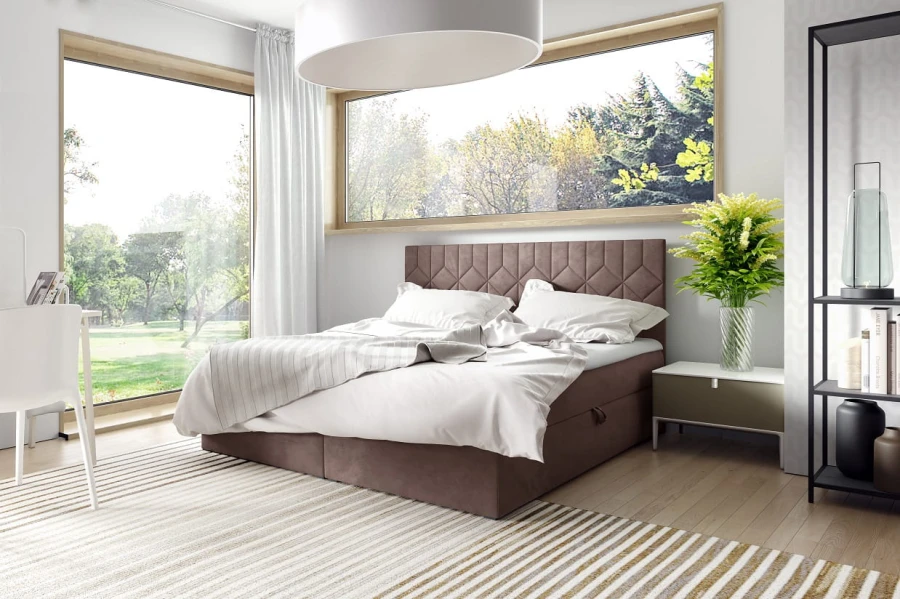 Braunes Boxspringbett mit gestepptem Kopfteil in hellem Schlafzimmer