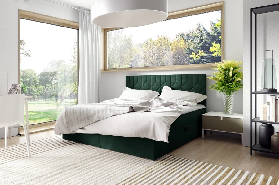 Modernes dunkelgrünes Boxspringbett in einem hell eingerichteten Schlafzimmer mit Naturview.
