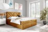 Senfgelbes Samt-Boxspringbett mit modernem Kopfteil-Design als Farbtupfer im Schlafzimmer.