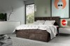 Dunkelbraunes Boxspringbett mit elegantem Rautenmuster im Kopfteil und weißer Bettwäsche.