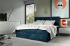 Modernes Boxspringbett in Blau mit weißer Bettwäsche im stilvollen Schlafzimmer.