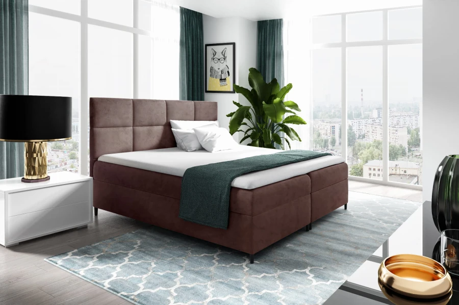 Stilvolles Boxspringbett in Mauve-Braun für ein gemütliches Ambiente im Schlafzimmer.