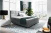 Elegantes graues Boxspringbett mit Samtbezug und quadratisch gestepptem Kopfteil.