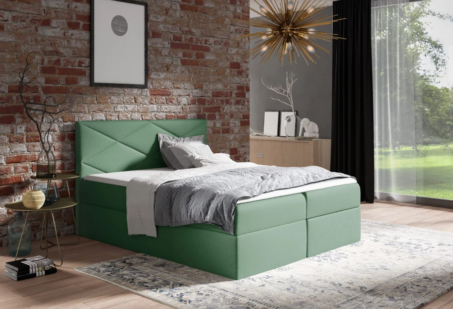 Grünes Boxspringbett im modernen Schlafzimmer mit Industrial-Charme und Backsteinoptik.