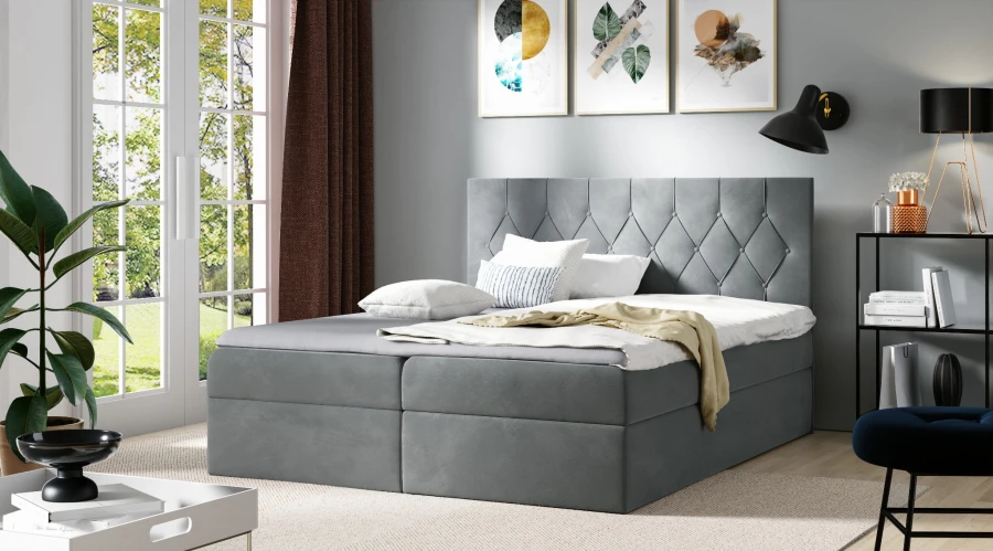 Graues Boxspringbett mit dekorativ gestepptem Kopfteil im Schlafzimmer