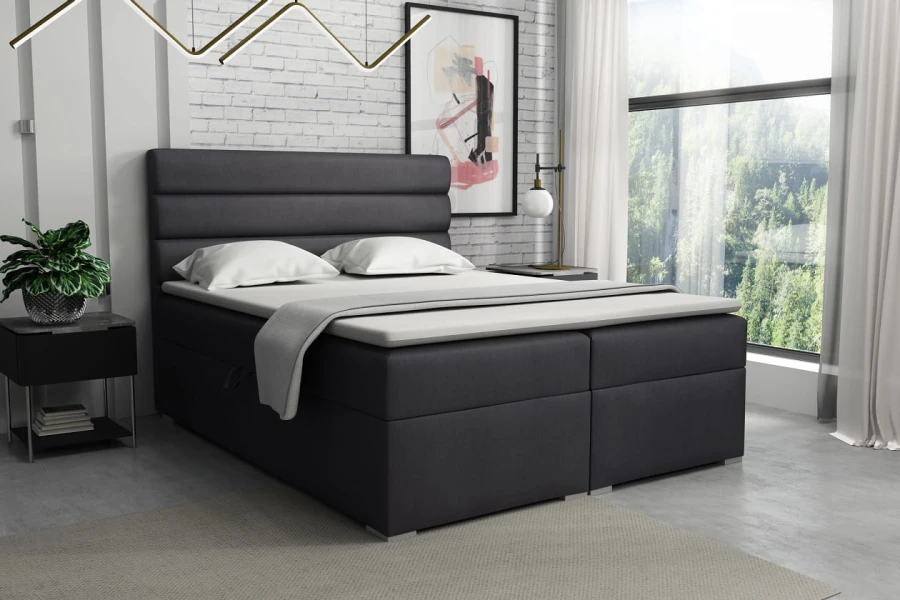 Anthrazitfarbenes Boxspringbett im Schlafzimmer mit heller Deko
