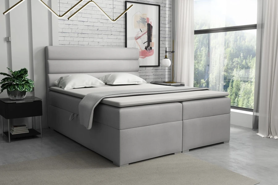 Stilvolles Boxspringbett in Hellgrau für ein modernes Schlafzimmer-Design.