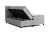 Graues Boxspringbett mit offenem Bettkasten für viel Stauraum.