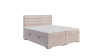 Rosa Boxspringbett mit Bettkasten und horizontal gestepptem Kopfteil auf weißem Hintergrund.