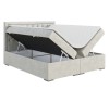 Graues Boxspringbett mit gestepptem Kopfteil und zwei offenen Bettkästen zur Aufbewahrung.
