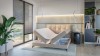 Modernes Schlafzimmer mit beigem Boxspringbett und praktischem Stauraum im Bettkasten.