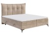 Elegantes beige gepolstertes Boxspringbett mit hohem Kopfteil und weißem Topper.