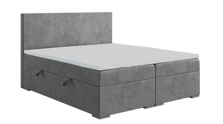 Graues Boxspringbett mit Bettkasten, hohem Kopfteil und Topper vor weißem Hintergrund.