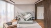 Stilvolles Schlafzimmer mit mintgrünem Samtbett inklusive Bettkasten-Funktion und moderner Wandgestaltung.