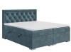 Blaues Boxspringbett mit gestepptem Kopfteil und weißem Topper vor weißem Hintergrund.
