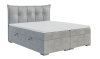 Modernes Boxspringbett in Grau mit elegant gestepptem Kopfteil und minimalistischem Design.