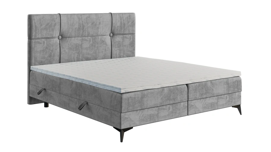 Gepolstertes graues Boxspringbett mit hohem Kopfteil isoliert auf weißem Grund.