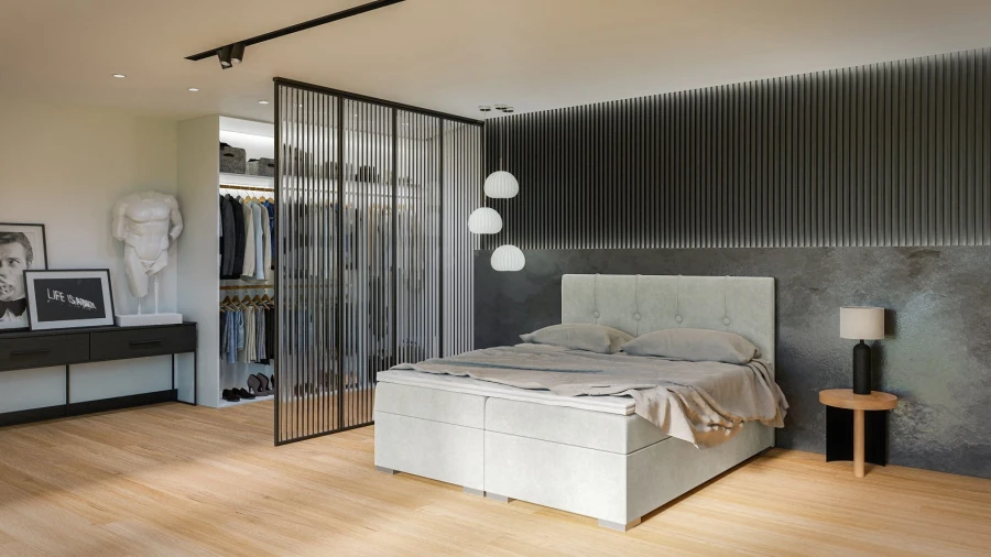 Modernes Schlafzimmer mit hellgrauem Boxspringbett und begehbarem Kleiderschrank hinter Lamellenwand.