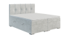 Hellgraues Boxspringbett mit gepolstertem Kopfteil und praktischem Bettkasten für Stauraum.
